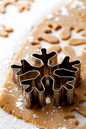 simsearch:400-05721521,k - Making gingerbread cookies for Christmas. Gingerbread dough with snowflake shapes. Stock Photo - Budget Royalty-Free & Subscription, Code: 400-05696401