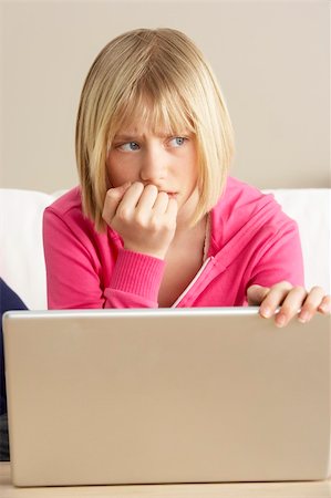 simsearch:400-05697169,k - Worried Looking Girl Using Laptop Stock Photo - Budget Royalty-Free & Subscription, Code: 400-05697194