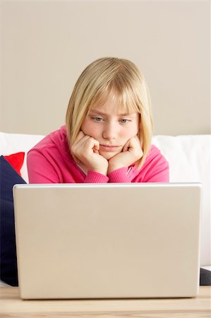 simsearch:400-05697169,k - Worried Looking Girl Using Laptop Stock Photo - Budget Royalty-Free & Subscription, Code: 400-05697191