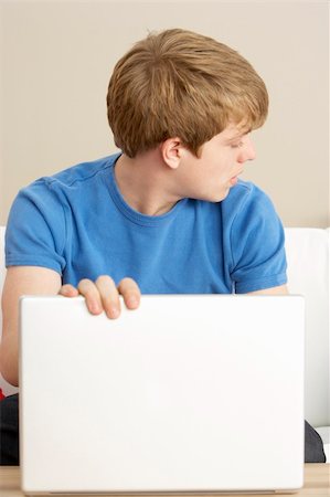 simsearch:400-05697169,k - Worried Looking Boy Using Laptop Stock Photo - Budget Royalty-Free & Subscription, Code: 400-05697211