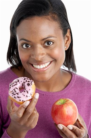 simsearch:400-05106591,k - Woman Choosing Between Apple And Doughnut Stock Photo - Budget Royalty-Free & Subscription, Code: 400-05697443