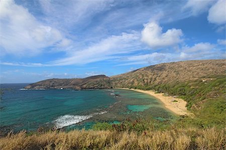 Wide-angle view of Hanauma Bay Nature Preserve near Honolulu, Hawaii with dramatic white clouds and a bright blue sky Stock Photo - Budget Royalty-Free & Subscription, Code: 400-05699064