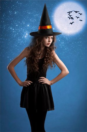 simsearch:400-05693792,k - very young girl dressed as halloween witch posing under stars and moon wearing a huge witch hat Stock Photo - Budget Royalty-Free & Subscription, Code: 400-05693467