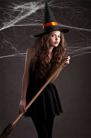 simsearch:400-05693792,k - cute young model dressed up as a halloween witch wearing a huge orange black hat Stock Photo - Budget Royalty-Free & Subscription, Code: 400-05693469