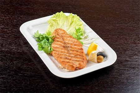 Grilled salmon steak with greens,onion, lemon, lime and olive Stock Photo - Budget Royalty-Free & Subscription, Code: 400-05705412