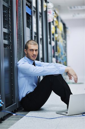 simsearch:400-04239432,k - young engeneer business man with thin modern aluminium laptop in network server room Stock Photo - Budget Royalty-Free & Subscription, Code: 400-05708151