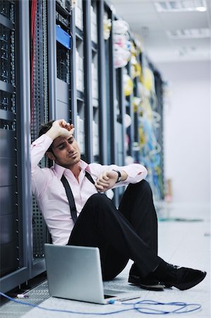 simsearch:400-04239432,k - young engeneer business man with thin modern aluminium laptop in network server room Stock Photo - Budget Royalty-Free & Subscription, Code: 400-05708152