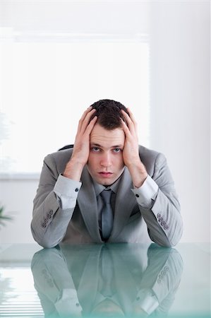 simsearch:400-05709555,k - Close up of businessman after failure sitting behind a table Stock Photo - Budget Royalty-Free & Subscription, Code: 400-05709561