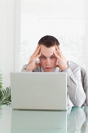 simsearch:400-05709564,k - Close up of disappointed young businessman getting bad news via email Stock Photo - Budget Royalty-Free & Subscription, Code: 400-05709633