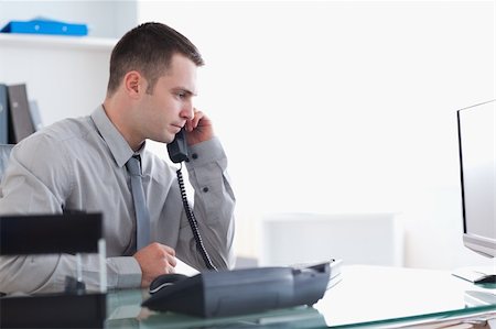 simsearch:400-05710264,k - Young businessman answering the phone Stock Photo - Budget Royalty-Free & Subscription, Code: 400-05709687