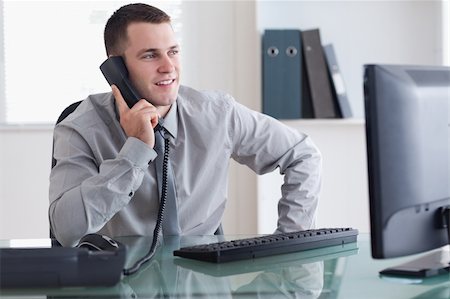 simsearch:400-05710264,k - Smiling businessman looking at the screen while on the phone Stock Photo - Budget Royalty-Free & Subscription, Code: 400-05709697