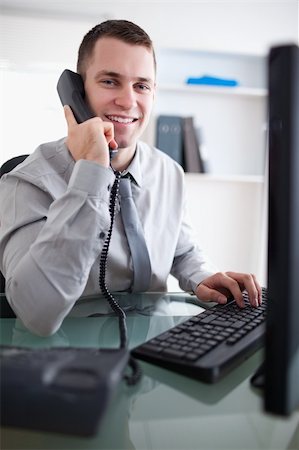 simsearch:400-05710264,k - Smiling young businessman having a dialogue on the phone Stock Photo - Budget Royalty-Free & Subscription, Code: 400-05709706