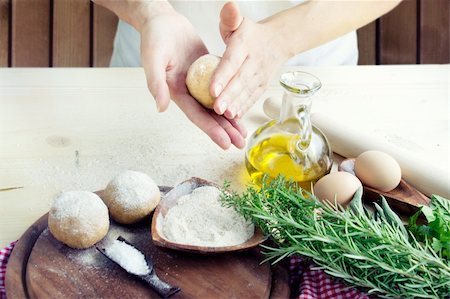 simsearch:649-06845217,k - Woman is kneading dough balls for pizza or pastry, pasta preparation in the bakery . Ingredients for dough: Olive oil, salt and herbs with flour Stock Photo - Budget Royalty-Free & Subscription, Code: 400-05701404