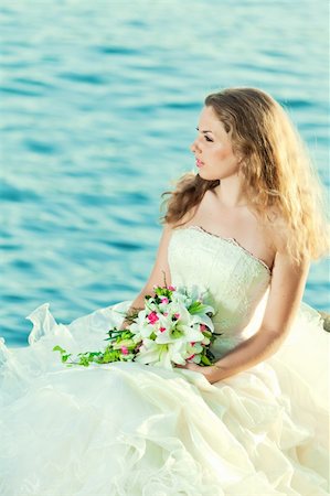 simsearch:400-05328142,k - Beautiful bride sitting on a rock in a sea Stock Photo - Budget Royalty-Free & Subscription, Code: 400-05703155