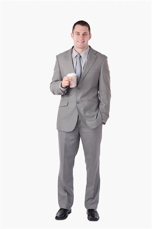 Portrait of a businessman holding a cup of tea against a white background Stock Photo - Budget Royalty-Free & Subscription, Code: 400-05714828