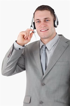 simsearch:400-03933798,k - Portrait of a smiling operator using a headset against a white background Stock Photo - Budget Royalty-Free & Subscription, Code: 400-05715024