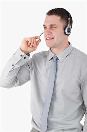 simsearch:400-03933798,k - Portrait of an assistant using a headset against a white background Stock Photo - Budget Royalty-Free & Subscription, Code: 400-05715026