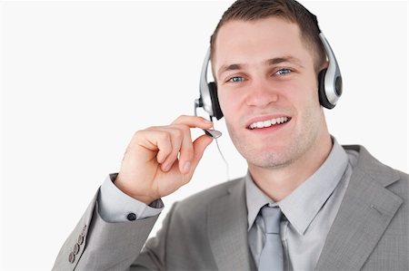 simsearch:400-03933798,k - Smiling operator using a headset against a white background Stock Photo - Budget Royalty-Free & Subscription, Code: 400-05715023