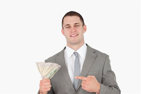 simsearch:400-05715208,k - Businessman pointing at a wad of cash against a white background Stock Photo - Budget Royalty-Free & Subscription, Code: 400-05715211