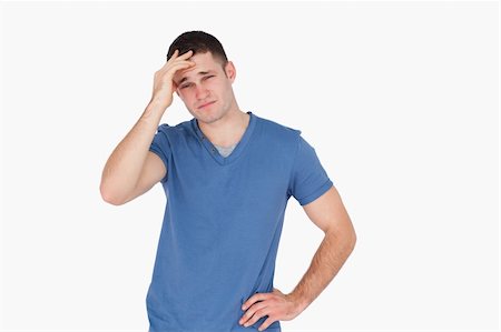 simsearch:400-04918265,k - Young man having a headache against a white background Stock Photo - Budget Royalty-Free & Subscription, Code: 400-05715259