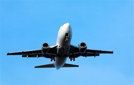 airplane landing on the blue sky background Stock Photo - Budget Royalty-Free & Subscription, Code: 400-05715456