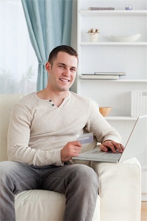 simsearch:400-04410667,k - Portrait of a man shopping online in his living room Stock Photo - Budget Royalty-Free & Subscription, Code: 400-05715533
