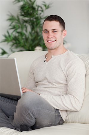 simsearch:400-04412244,k - Portrait of a happy man relaxing with a notebook in his living room Stock Photo - Budget Royalty-Free & Subscription, Code: 400-05715593