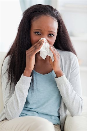 simsearch:400-05716904,k - Close up of young woman on couch blowing her nose Stock Photo - Budget Royalty-Free & Subscription, Code: 400-05716894