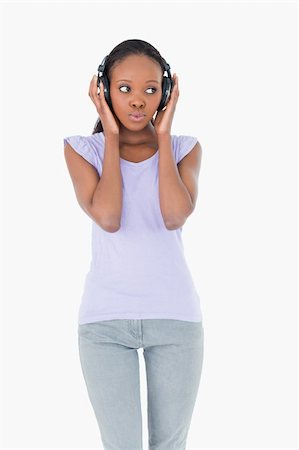 simsearch:400-05717451,k - Close up of young woman listening to music on white background Stock Photo - Budget Royalty-Free & Subscription, Code: 400-05717349