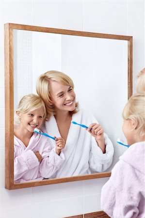 family bathroom mirror - Mother and daughter brushing their teeth in the bathroom Stock Photo - Budget Royalty-Free & Subscription, Code: 400-05717393