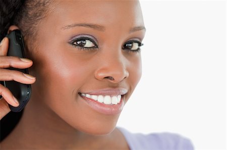 simsearch:400-05717347,k - Close up of young woman listening closely to caller on white background Photographie de stock - Aubaine LD & Abonnement, Code: 400-05717426