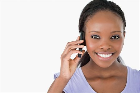 simsearch:400-05717347,k - Close up of young smiling woman on the phone on white background Photographie de stock - Aubaine LD & Abonnement, Code: 400-05717420