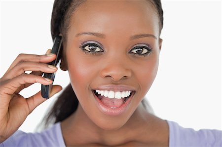 simsearch:400-05717423,k - Close up of surprised looking young woman on the phone on white background Stock Photo - Budget Royalty-Free & Subscription, Code: 400-05717433