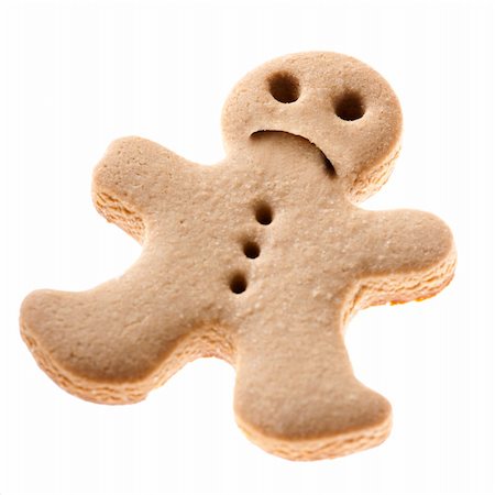 simsearch:400-05721521,k - Homemade Gingerbread man cookie with a sad expression isolated on white background Stock Photo - Budget Royalty-Free & Subscription, Code: 400-05717534