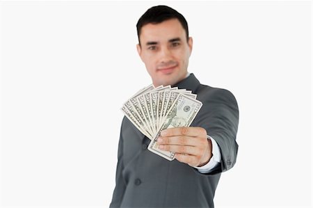 simsearch:400-05718324,k - Businessman presenting bank notes against a white background Stock Photo - Budget Royalty-Free & Subscription, Code: 400-05718325