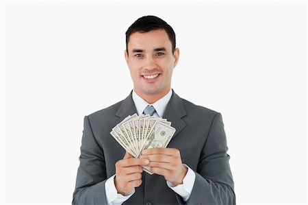 simsearch:400-05718324,k - Businessman with money against a white background Stock Photo - Budget Royalty-Free & Subscription, Code: 400-05718321