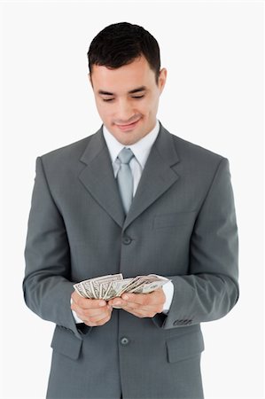 simsearch:400-05715208,k - Businessman counting bank notes against a white background Stock Photo - Budget Royalty-Free & Subscription, Code: 400-05718336