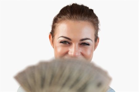 simsearch:400-05715208,k - Close up of smiling businesswoman showing her bank notes against a white background Stock Photo - Budget Royalty-Free & Subscription, Code: 400-05718531