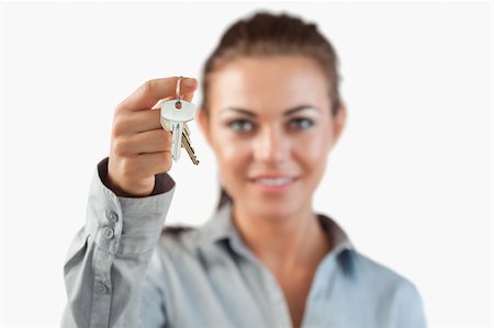 simsearch:400-04663994,k - Close up of keys being held by female estate agent against a white background Stock Photo - Budget Royalty-Free & Subscription, Code: 400-05718533