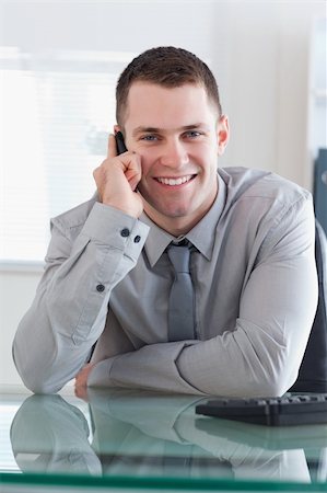 simsearch:400-05710264,k - Businessman getting a pleasant call on his cellphone Stock Photo - Budget Royalty-Free & Subscription, Code: 400-05710251