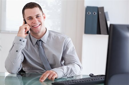 simsearch:400-05710264,k - Smiling businessman getting pleasant news on the cellphone Stock Photo - Budget Royalty-Free & Subscription, Code: 400-05710265
