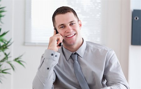 simsearch:400-05710264,k - Smiling businessman getting pleasant news on the mobile phone Stock Photo - Budget Royalty-Free & Subscription, Code: 400-05710266