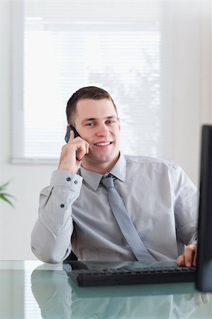 simsearch:400-05710264,k - Smiling happy businessman getting good news on the cellphone Stock Photo - Budget Royalty-Free & Subscription, Code: 400-05710269