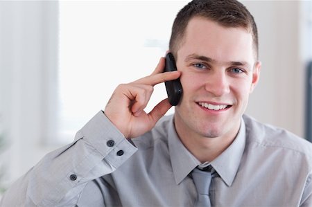 simsearch:400-05710264,k - Smiling young businessman getting good news on the phone Stock Photo - Budget Royalty-Free & Subscription, Code: 400-05710262