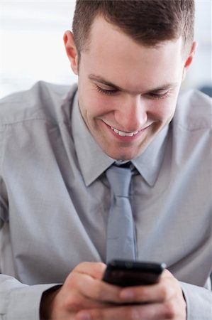 simsearch:400-05710264,k - Close up of smiling businessman getting a pleasant text message Stock Photo - Budget Royalty-Free & Subscription, Code: 400-05710277