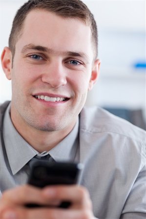 simsearch:400-05710264,k - Close up of young businessman with mobile phone in his hands Stock Photo - Budget Royalty-Free & Subscription, Code: 400-05710279