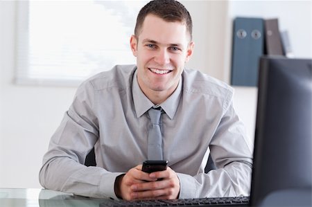 simsearch:400-05710264,k - Smiling businessman happy about a text message Stock Photo - Budget Royalty-Free & Subscription, Code: 400-05710272