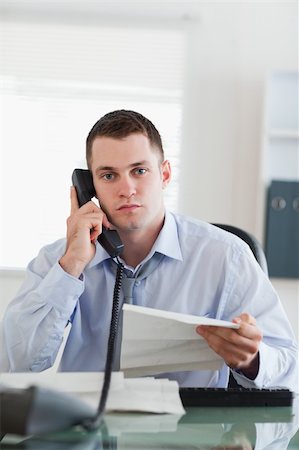 simsearch:400-05710264,k - Close up of young businessman calling the author of a letter Stock Photo - Budget Royalty-Free & Subscription, Code: 400-05710305