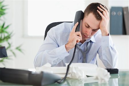 simsearch:400-05710264,k - Frustrated businessman looking at an invoice while on the phone Stock Photo - Budget Royalty-Free & Subscription, Code: 400-05710301