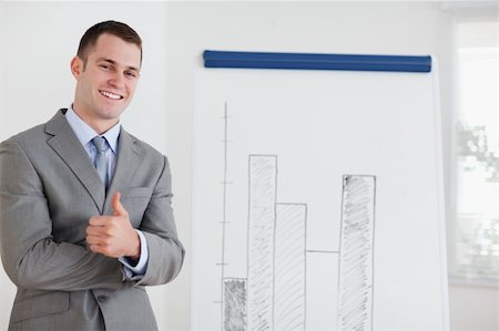 simsearch:400-05710386,k - Smiling businessman giving thumb up next to diagram Stock Photo - Budget Royalty-Free & Subscription, Code: 400-05710382